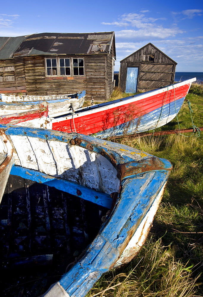 Old fishing boats and delapidated fishermens huts, Beadnell, Northumberland, England, United Kingdom, Europe