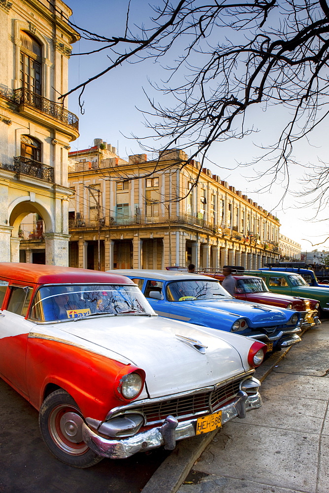 Classic American cars used as taxis for local people, parked outside the main railway station, Havana, Cuba, West Indies, Central America