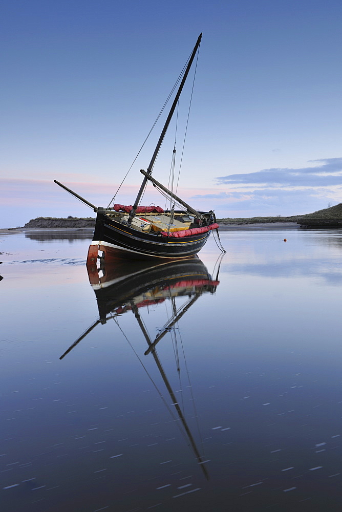 Old ketch reflecting in Aln Estuary as tide rises, Alnmouth, Northumberland, England, United Kingdom, Europe