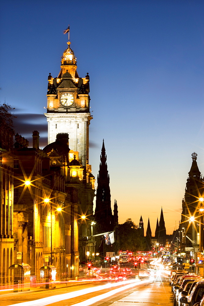 View along Waterloo Place at night towards Princes Street and the floodlit tower of the Balmoral Hotel, Edinburgh, Lothian, Scotland, United Kingdom, Europe