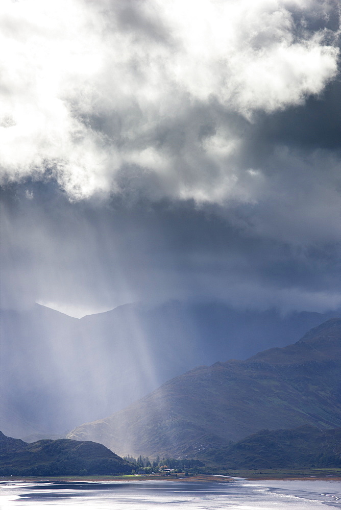 View from Carr Brae towards head of Loch Duich and Five Sisters of Kintail with sunlight bursting through sky, Highlands, Scotland, United Kingdom, Europe