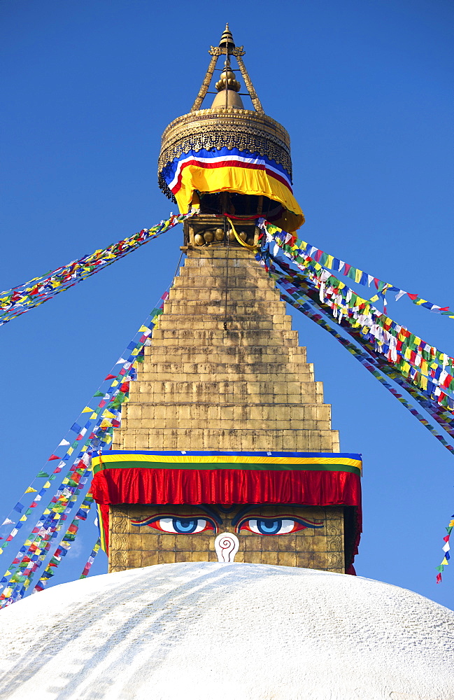 Bodhnath Stupa (Boudhanth) (Boudha), one of the holiest Buddhist sites in Kathmandu, UNESCO World Heritage Site, with colourful prayer flags against blue sky, Kathmandu, Nepal, Asia