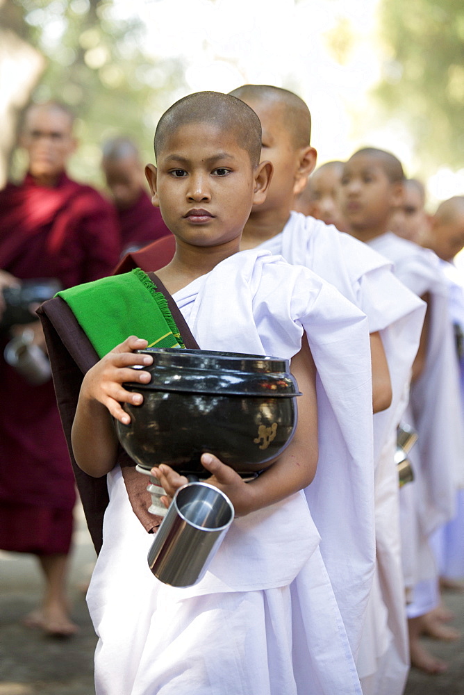 Novice Buddhist nuns queueing for a meal at Mahagandayon Monastery, where some 2000 monks and nuns are fed daily, Mandalay, Myanmar (Burma), Asia