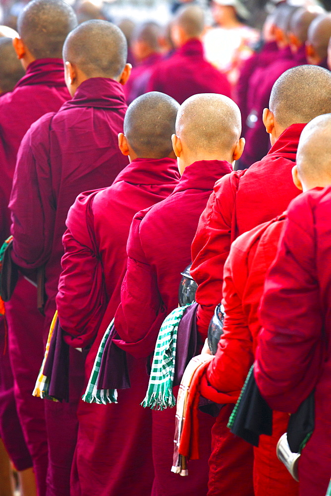 Buddhist monks queuing for a meal at Mahagandayon Monastery, where some 2000 monks are fed daily, Mandalay, Myanmar (Burma), Southewast Asia