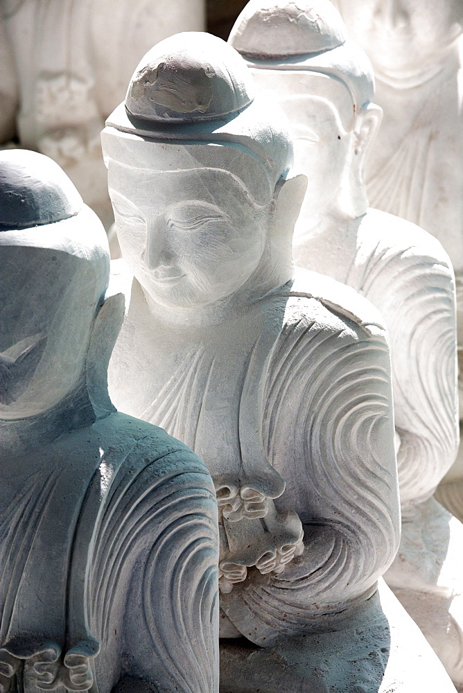 Marble Buddha images waiting to be finished at a stone carver's in Amarapura, near Mandalay, Myanmar (Burma), Southeast Asia