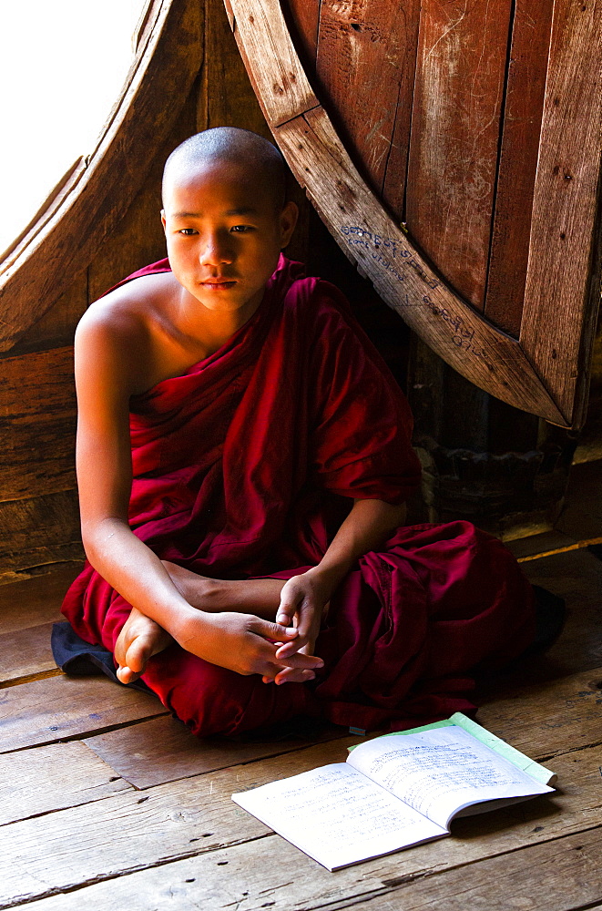 Novice Buddhist monk in lesson at Shwe Yaunghwe Kyaung, a famous teak monastery, Nyaungshwe, Inle Lake, Shan State, Myanmar (Burma),Asia