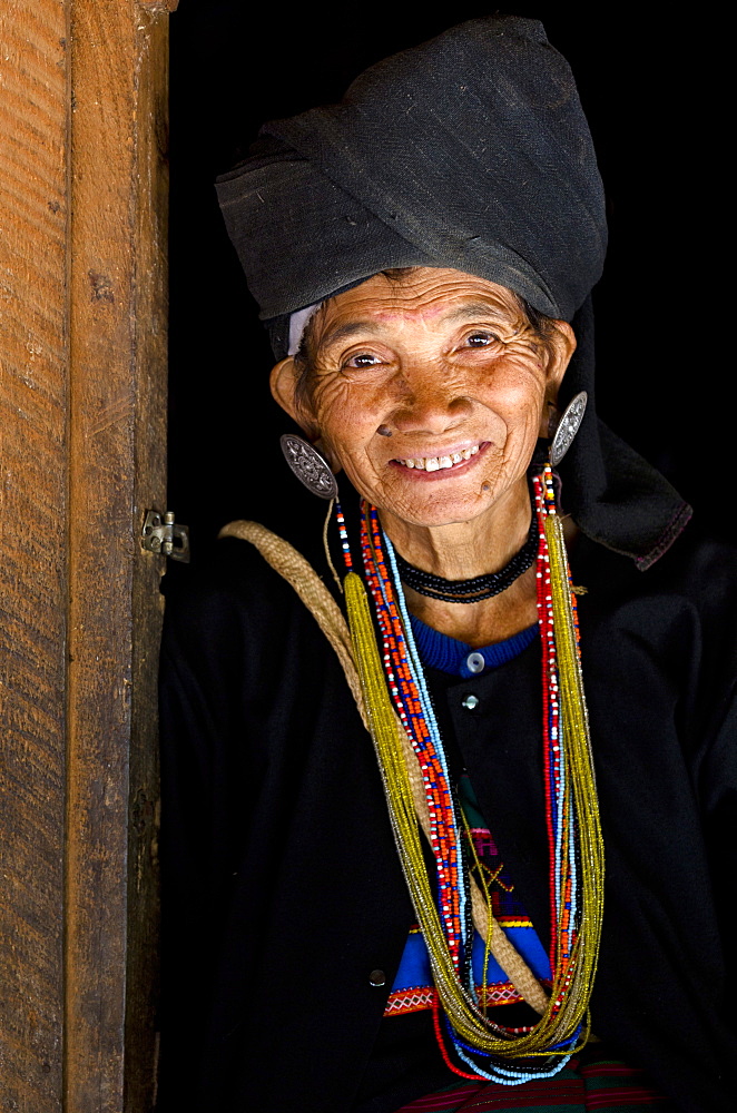 Woman of the Ann tribe in traditional black dress and colourful beads in a hill village near Kengtung (Kyaingtong), Shan State, Myanmar (Burma), Asia