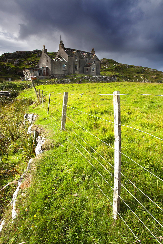 Abandoned croft beneath a stormy sky in the township of Manish on the east coast of The Isle of Harris, Outer Hebrides, Scotland