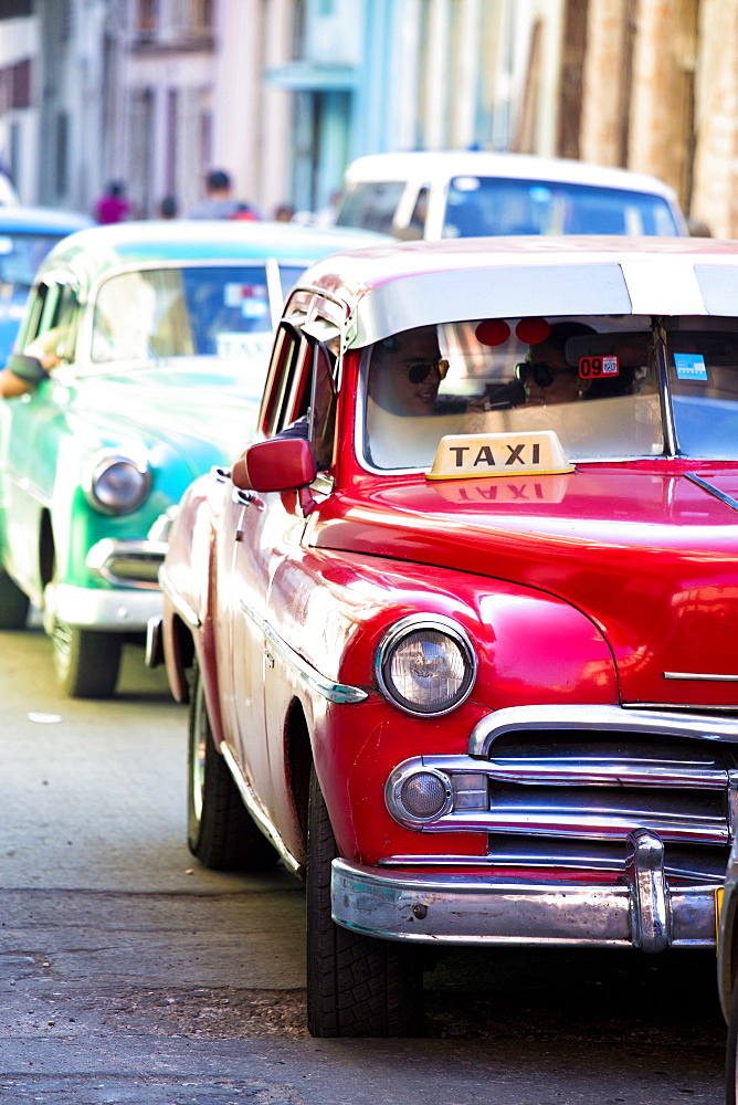 Vintage American cars used as local taxis, driving down Avenue Colon during afternoon rush hour, Havana Centro, Havana, Cuba, West Indies, Central America