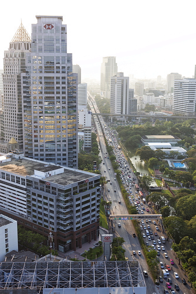 View of high rise buildings and traffic congestion on Rama IV in hazy evening light, from the roof of Hotel Sofitel So, Sathorn Road, Bangkok, Thailand, Southeast Asia, Asia