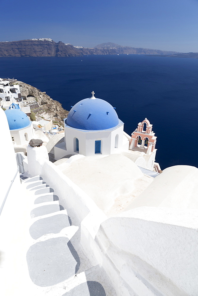 Steps leading to white church with blue dome overlooking the Caldera, Oia, Santorini, Cyclades, Greek Islands, Greece, Europe