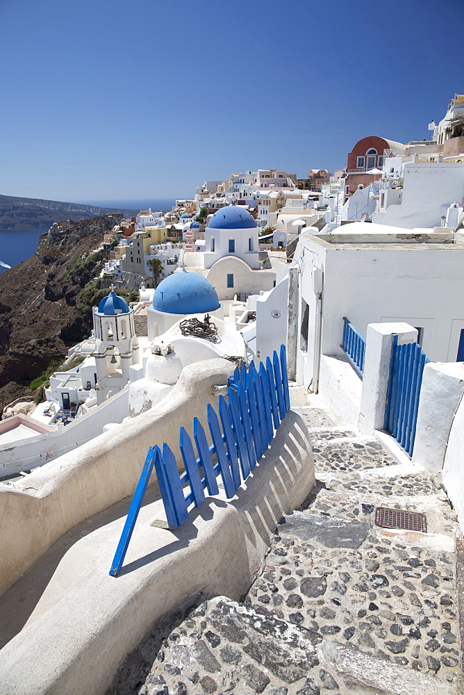 Classic view of the village of Oia with its blue domed churches and colourful houses, Oia, Santorini, Cyclades, Greek Islands, Greece, Europe