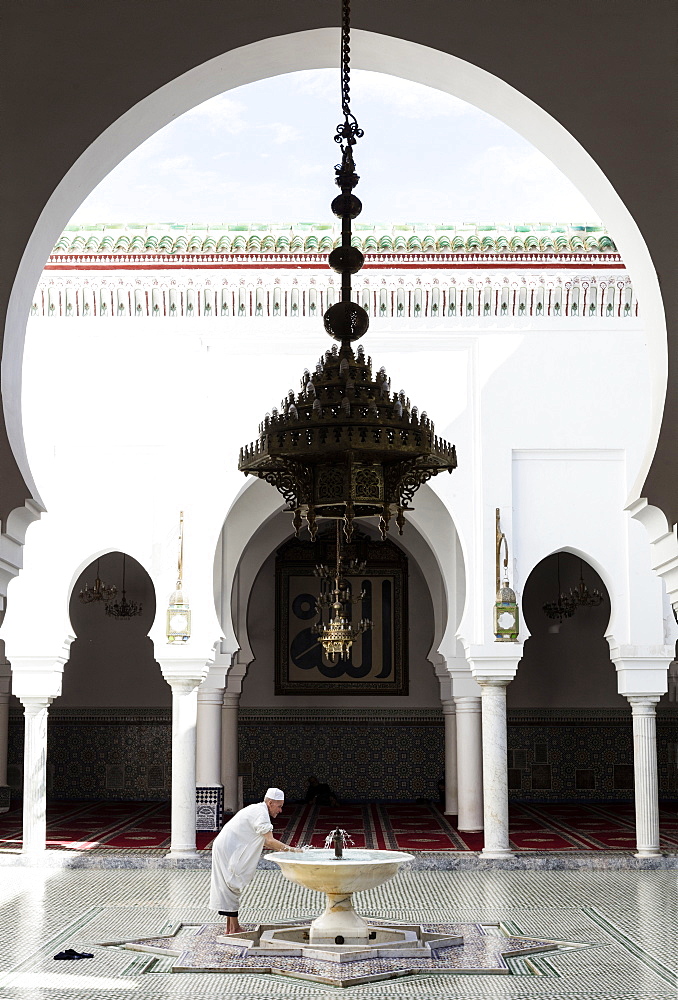 Local man washing in courtyard of Kairaouine Mosque (Mosque of al-Qarawiyyin), UNESCO World Heritage Site, Fez, Morocco, North Africa, Africa