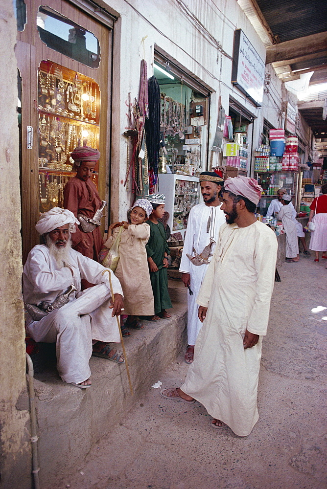 People gathered outside souk, Nizwa, Oman, Middle East