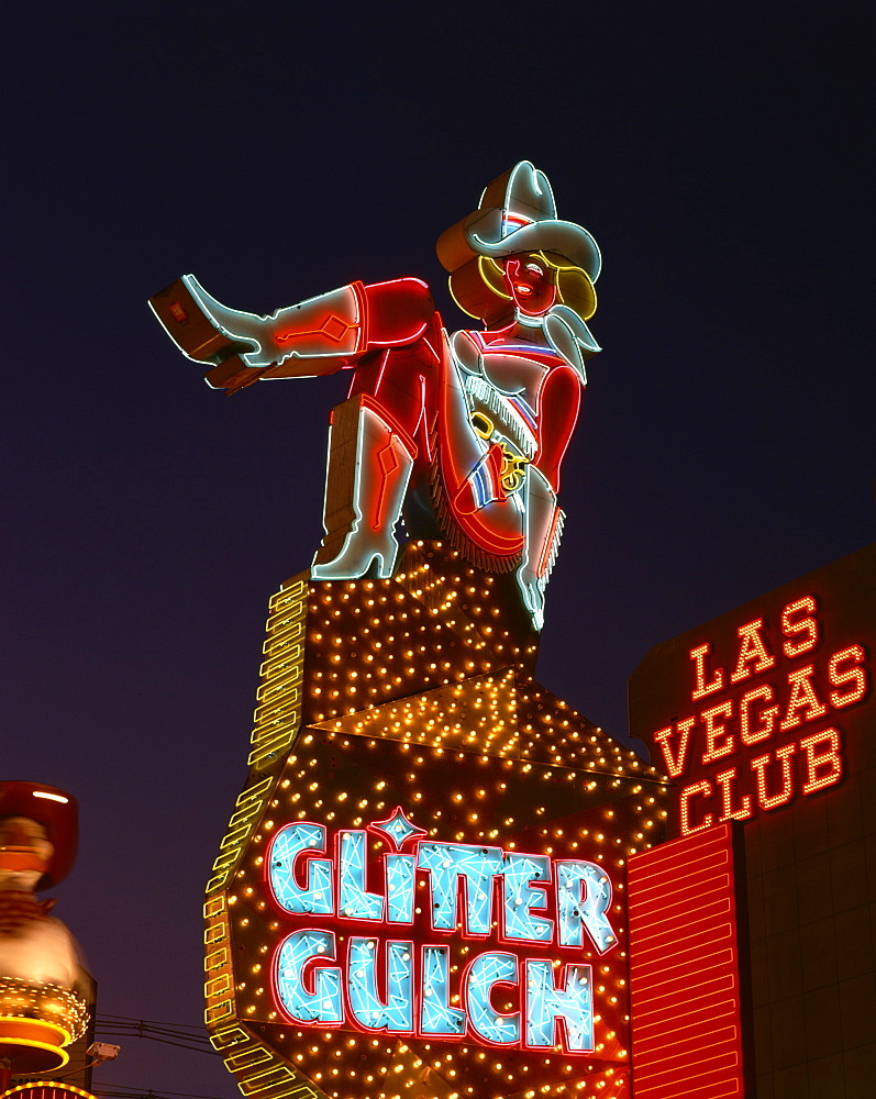 Close-up of neon sign of a cowgirl advertising Glitter Gulch at night in Las Vegas, Nevada, United States of America, North America