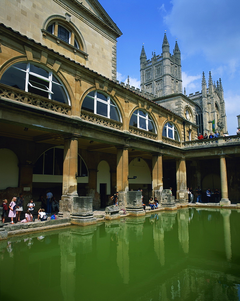 Visitors in the Roman Baths, with the Abbey beyond in Bath, UNESCO World Heritage Site, Avon, England, United Kingdom, Europe