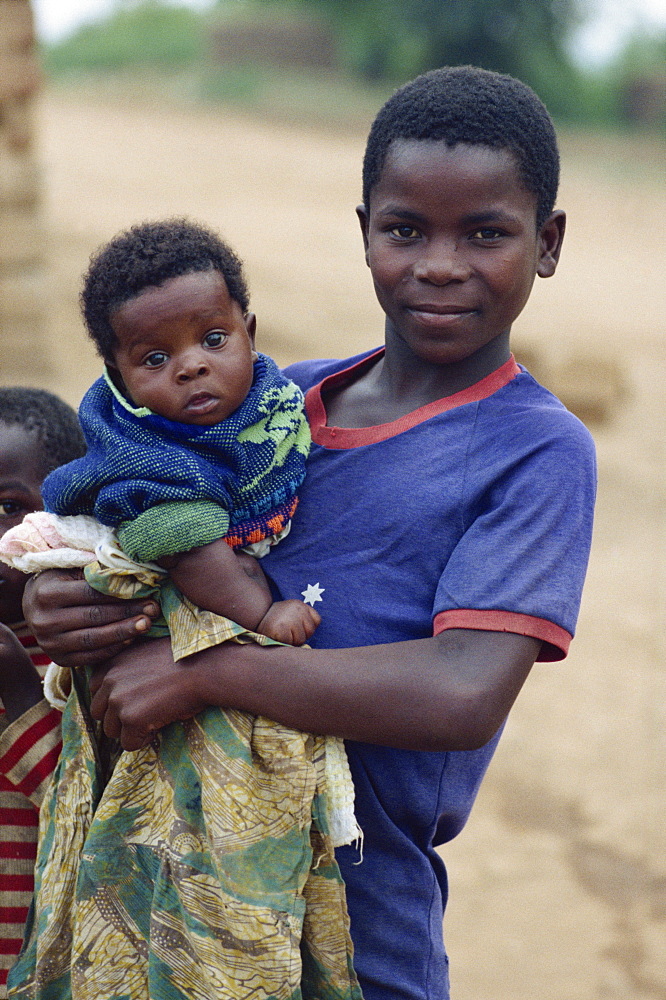 Girl holding baby, near Masaka, Uganda, East Africa, Africa