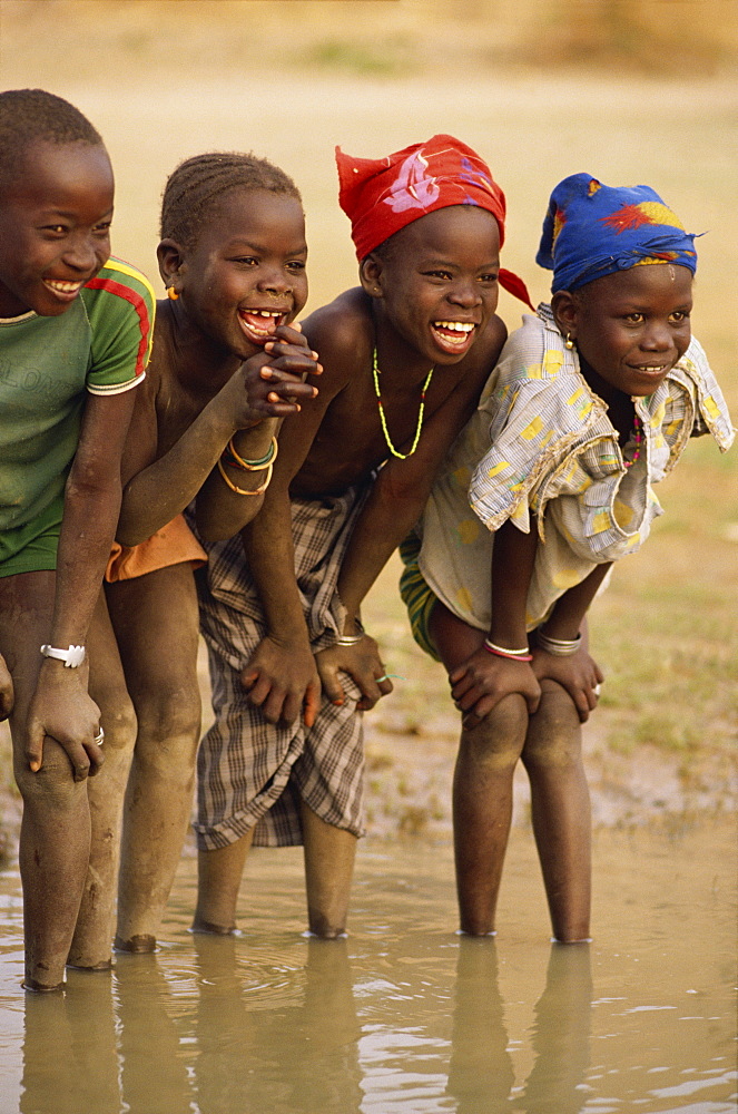 Group of young children smiling, paddling in the Niger River, Mali, West Africa, Africa