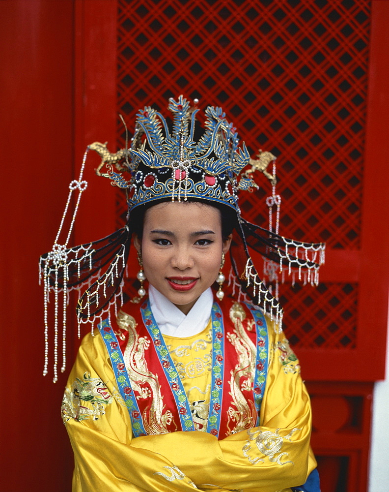 Portrait of a woman in the traditional costume of the Middle Kingdom in Hong Kong, China, Asia