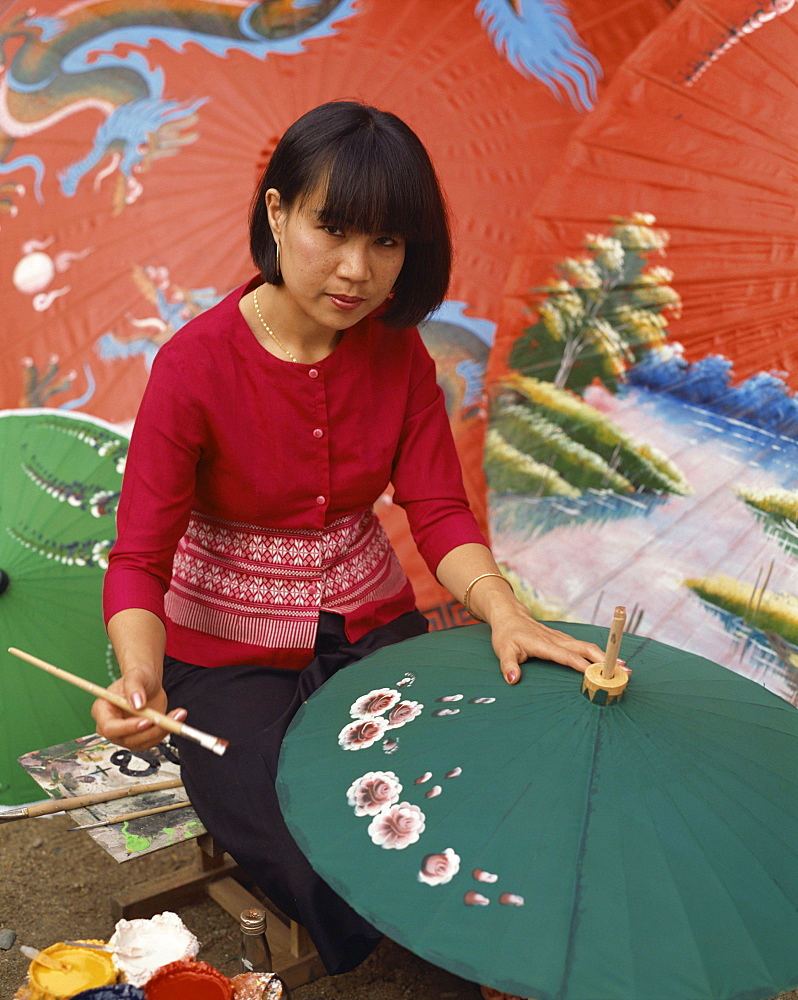 Portrait of a woman hand painting umbrellas in Chiang Mai, Thailand, Southeast Asia, Asia