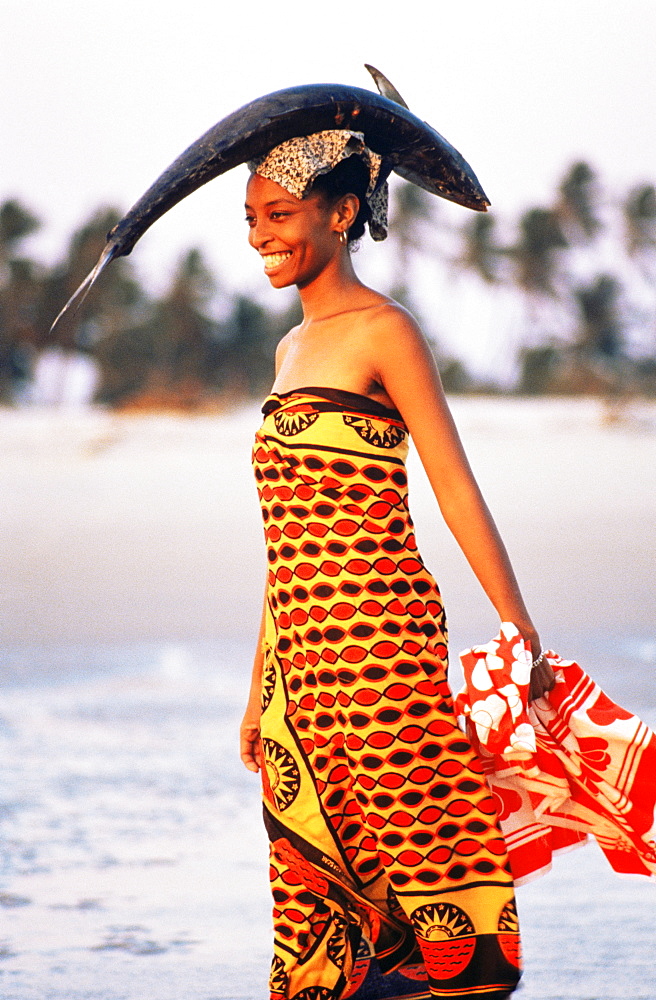 Woman carrying fish on her head, Majunga, Madagascar, Africa