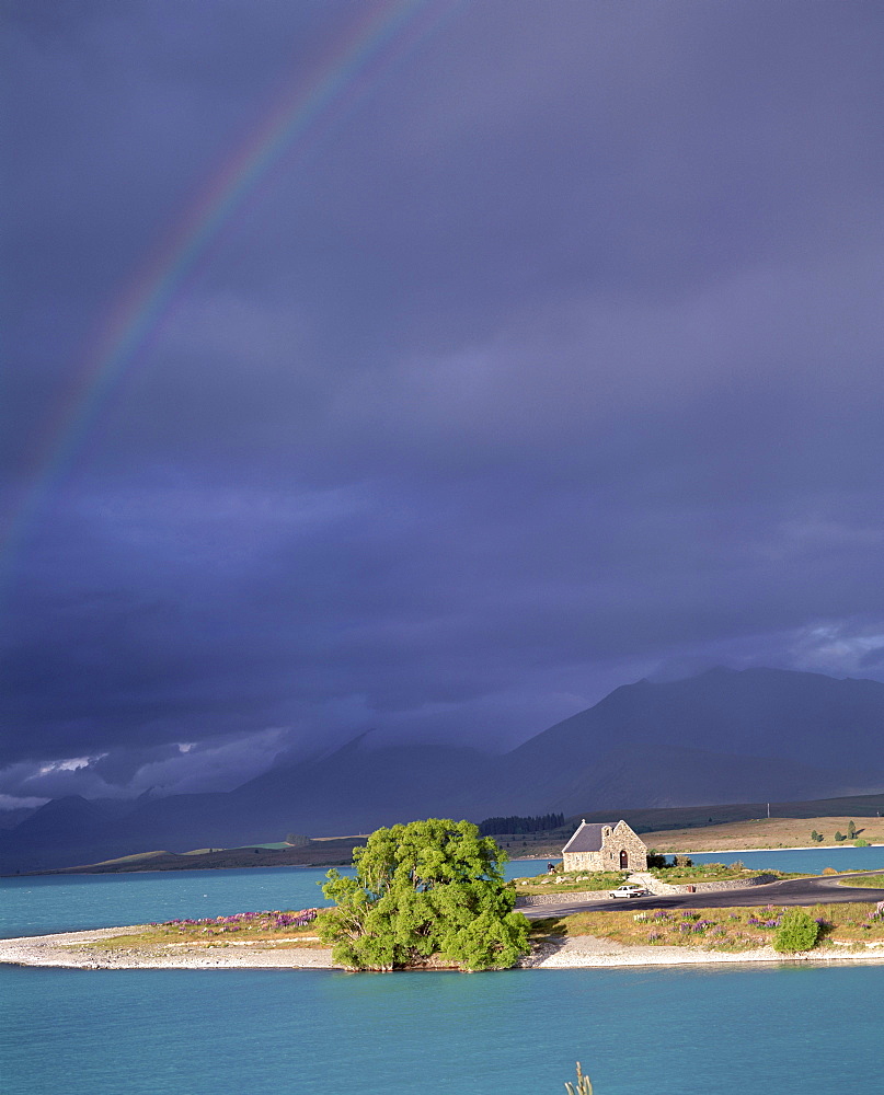 Rainbow and storm approaching, Christian Church of the Good Shepherd, Lake Tekapo, with Two Thumb Range beyond, Canterbury, South Island, New Zealand, Pacific