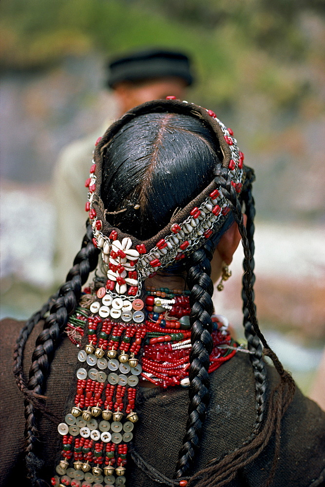 The back view of a womans head-dress and greased hair at Rumboor in Kafiristan, Pakistan, Asia