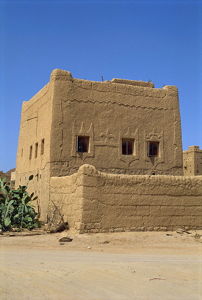 Mud built fortress house with decorated windows, Farawah, north Yemen, Middle East