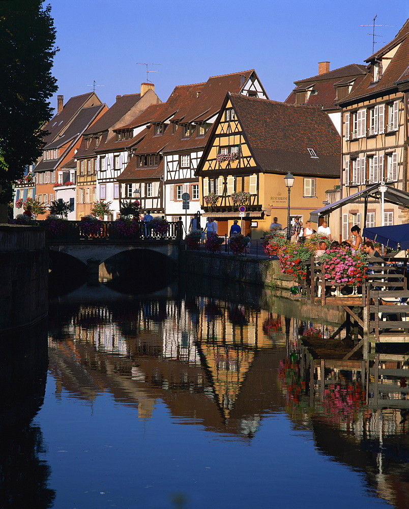 Timbered houses reflected in water in the evening, Petite Venise, Colmar, Haut-Rhin, Alsace, France, Europe