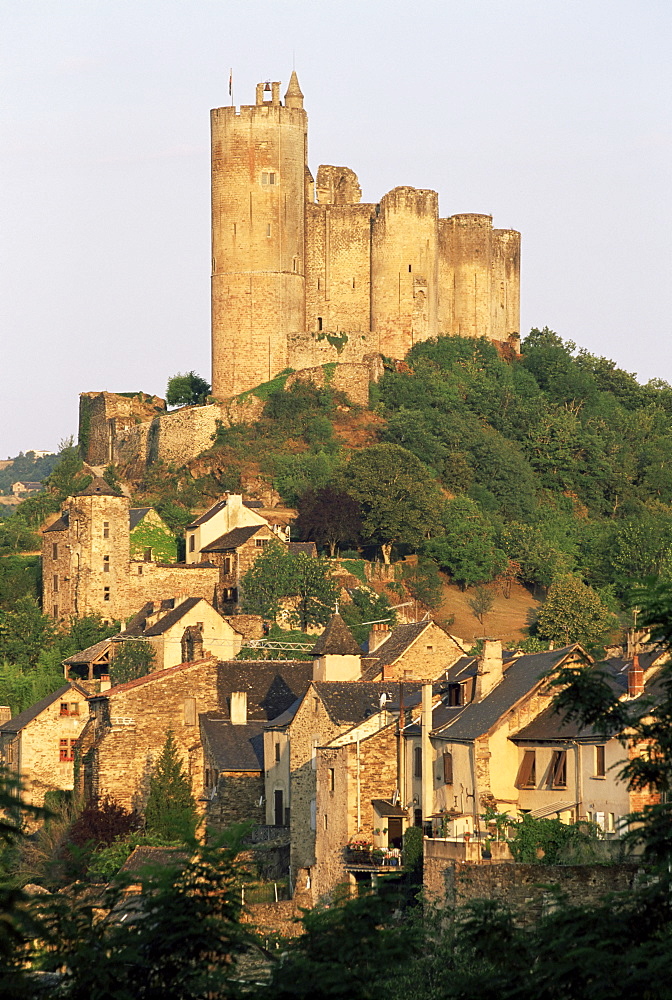 The castle towering above village houses, in early morning light, Najac, Aveyron, Midi-Pyrenees, France, Europe