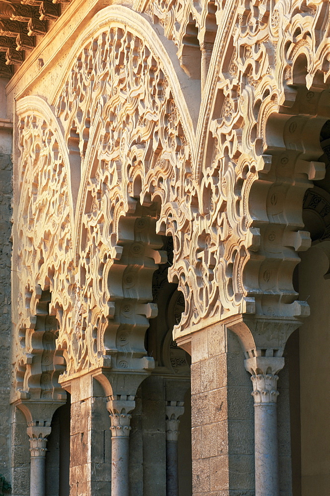 Intricately carved Moorish architecture lining the Patio de Santa Isabel, The Aljaferia, Zaragoza, Aragon, Spain, Europe