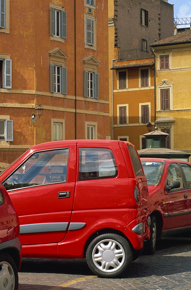 Small red car parked in square off Via Giulia, Rome, Lazio, Italy, Europe