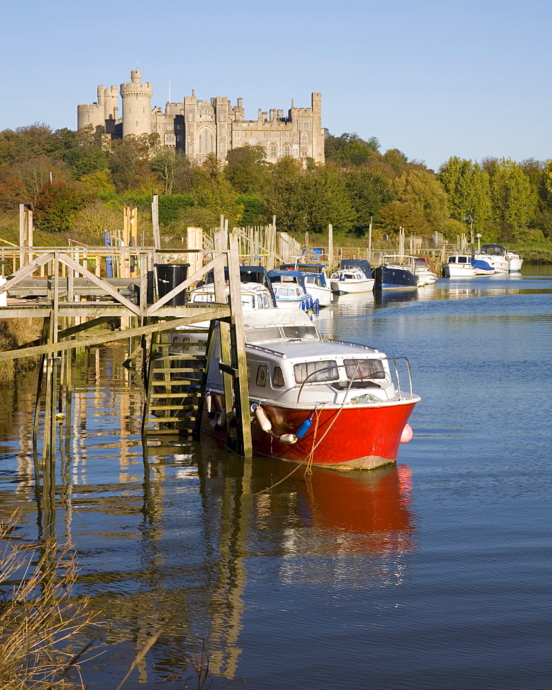 Colourful boats moored on the River Arun beneath the castle, Arundel, West Sussex, England, United Kingdom, Europe