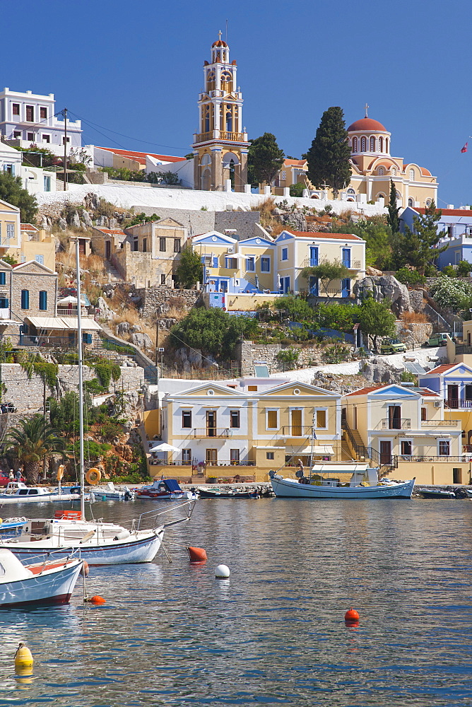 View over harbour to colourful houses and church, Gialos (Yialos), Symi (Simi), Rhodes, Dodecanese Islands, South Aegean, Greece, Europe