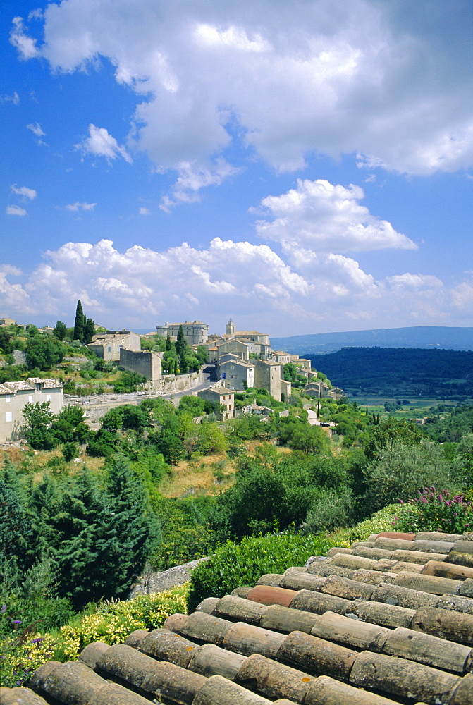 View over rooftops to village, Gordes, Luberon, Vaucluse, Provence, France, Europe