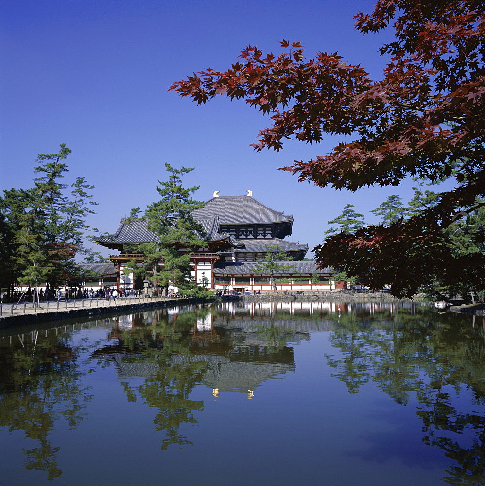 Exterior of Daibutsen-den hall of the Great Buddha, dating from 1709, reflected in water, Todai-ji Temple, Nara, Kansai, Japan, Asia