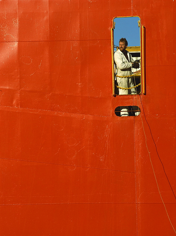 Ship cargo loader framed in hull doorway, Lyttleton Harbour, South Island, New Zealand, Pacific