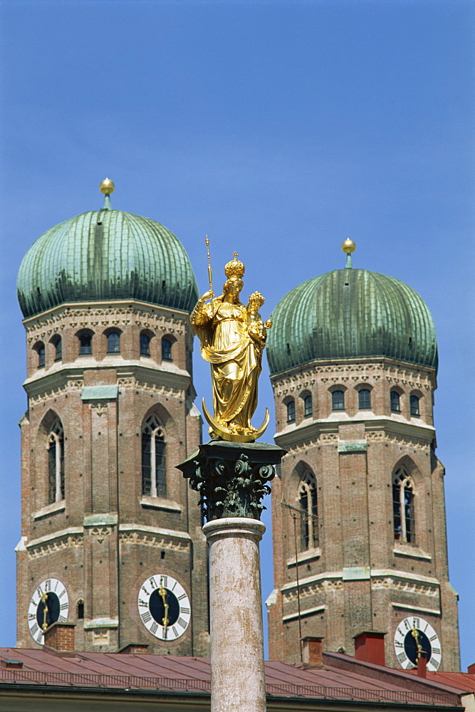 Gilded statue in the Marienplatz and towers of the Frauenkirche in Munich, Bavaria, Germany, Europe