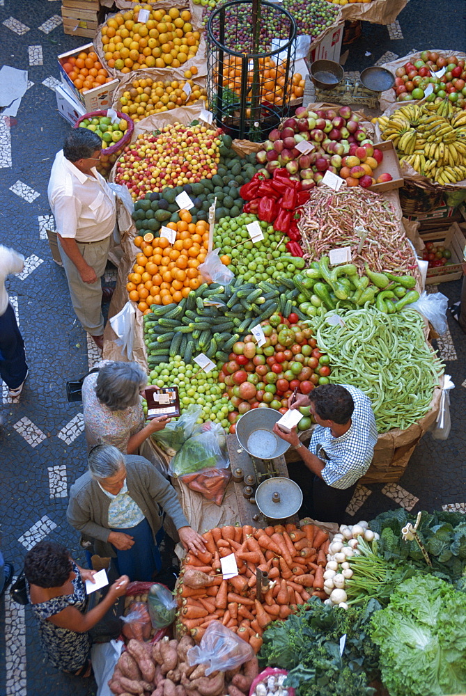 People at a fruit and vegetable stall in the market hall in Funchal, on the island of Madeira, Portugal, Europe