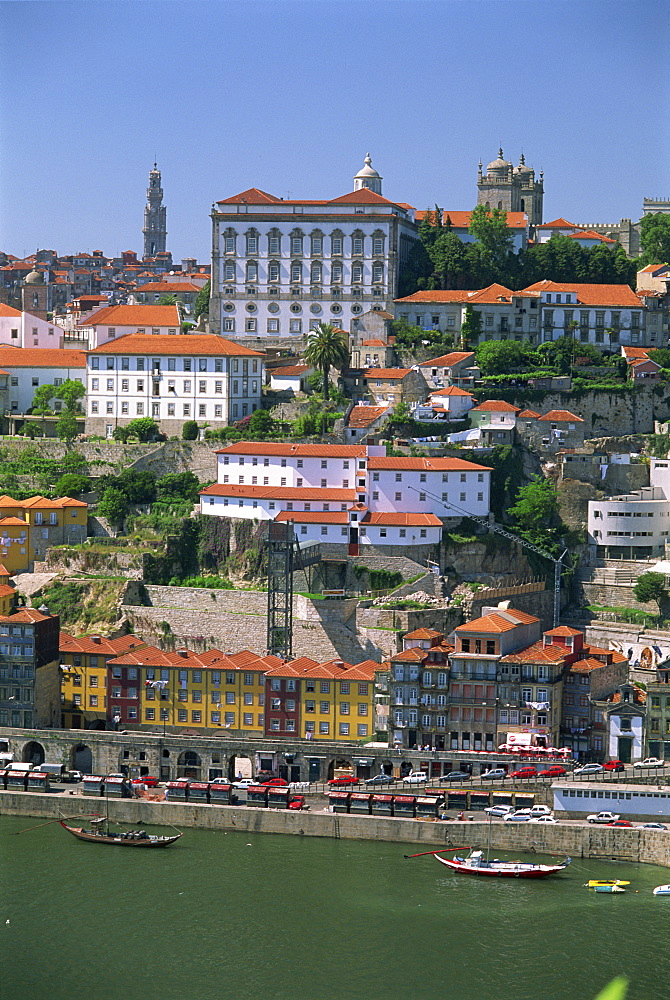 The Ribeira district on the waterfront of the Douro River, with the white facade of the Bishops Palace above, in the centre of Oporto, Portugal, Europe