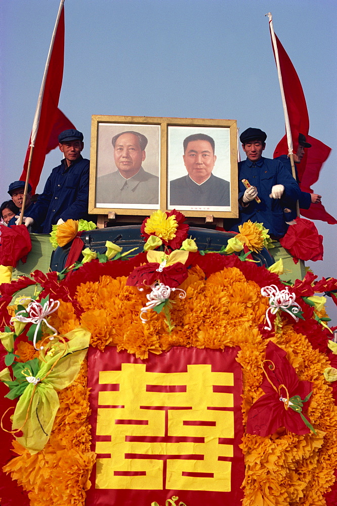 Photograph taken in the 1960s of a truck decorated with portraits of Hua Kuo-feng and Mao Tse Tung during festive parade, Beijing, China, Asia