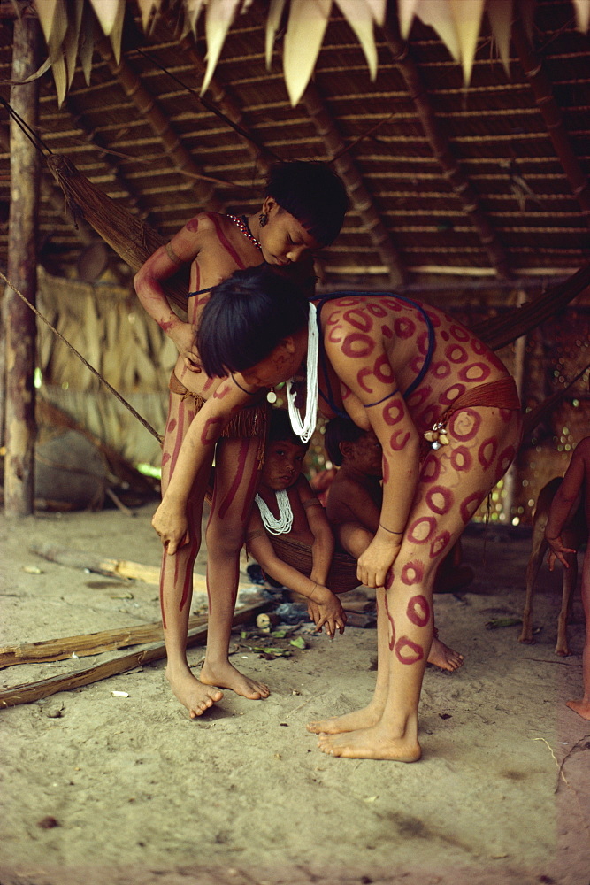 Yanomami indian girls painting each other, Brazil, South America