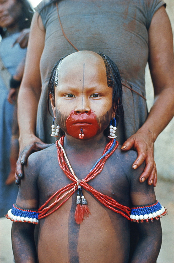 Portrait of a Kuben Kran Keen Indian child with facial decoration in Brazil, South America