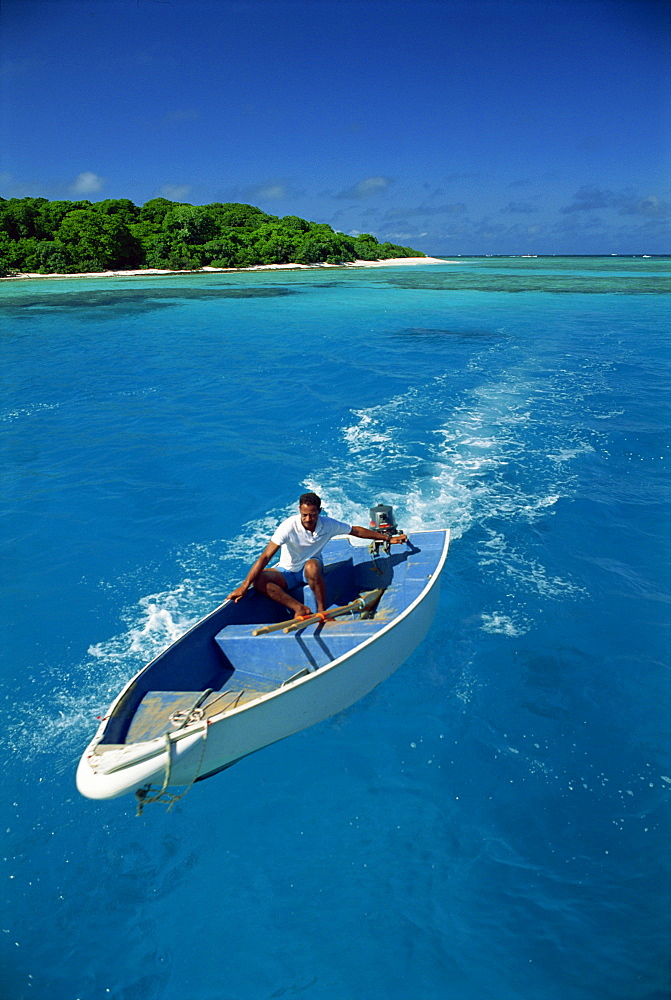 Man driving small boat, Maninita Island, Vava'u Group, Tonga, Pacific Islands, Pacific