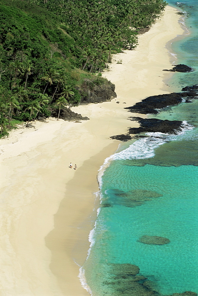 View down west coast of Yasawa Island, with two figures on beach, Fiji, Pacific Islands, Pacific