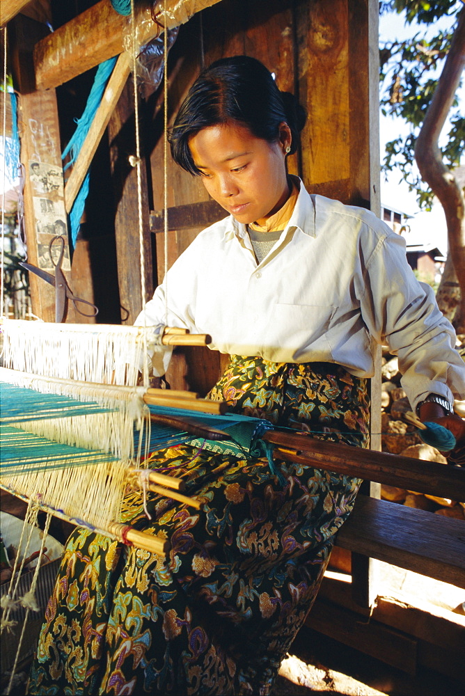 Intha girl weaves longyis, Inle Lake, Myanmar, Asia