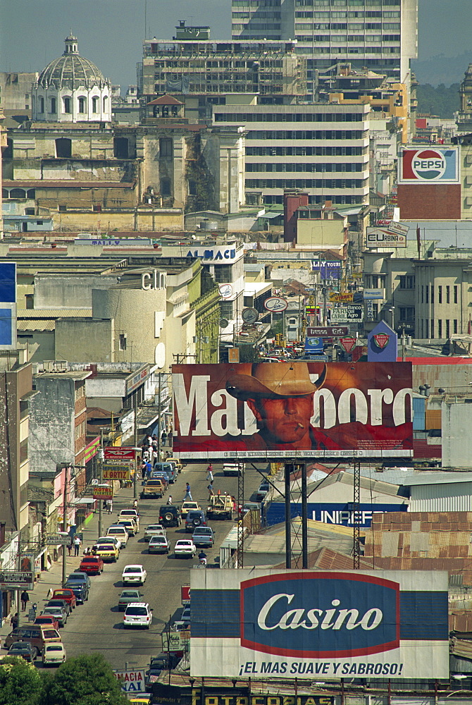 View down 7 Avenida with advertising signs and buildings in Guatemala City, Guatemala, Central America