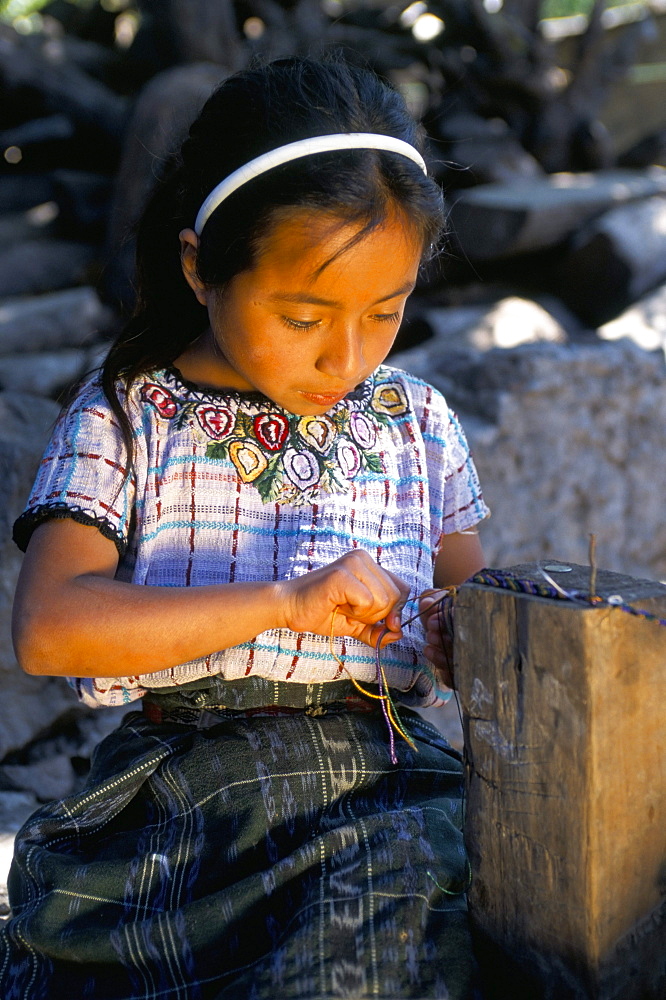 Girl making friendship bracelet, Santiago Atitlan, Guatemala, Central America