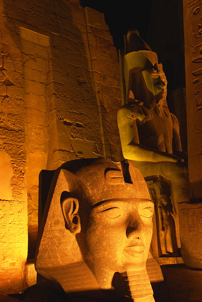 Floodlit statues of Ramses II, Temple of Luxor, UNESCO World Heritage Site, Luxor, Thebes, Egypt, North Africa, Africa