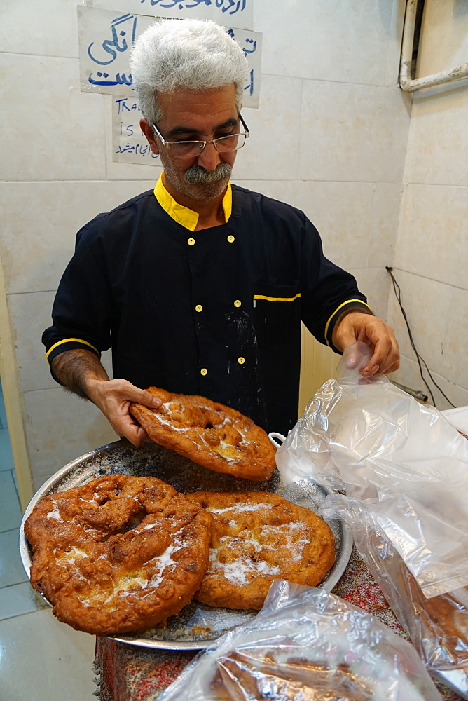 Traditional surouk (flat doughnuts) baker, Yazd, Iran, Middle East